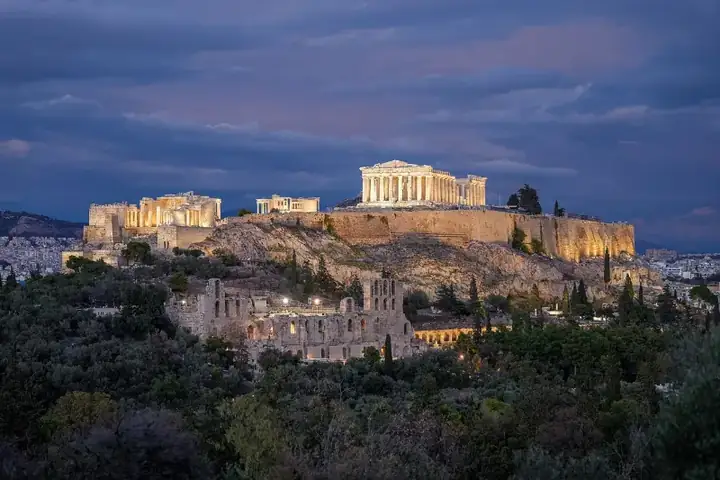 Acropolis of Athens in Greece at night Photo by Giles Laurent