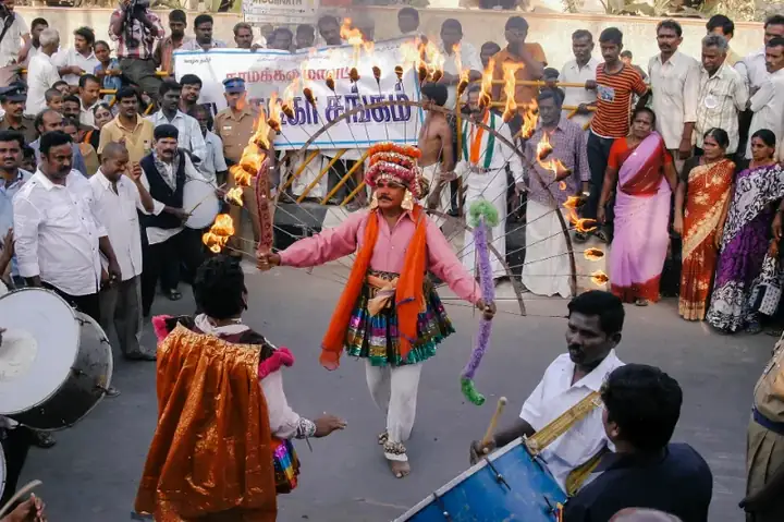 A man dancing with fire at a Pongal Festival in Namakkal, Tamil Nadu, India