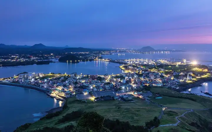 Seongsan ri town at blue hour seen from Seongsan Ilchulbong volcano Jeju Island South Korea