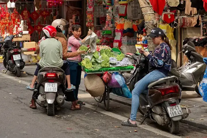 Street seller of fingered citrons in Old Town of Hanoi